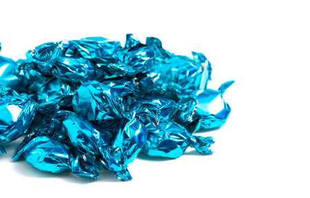 A Pile of Blue Wrapped Candy Isolated on a White Background