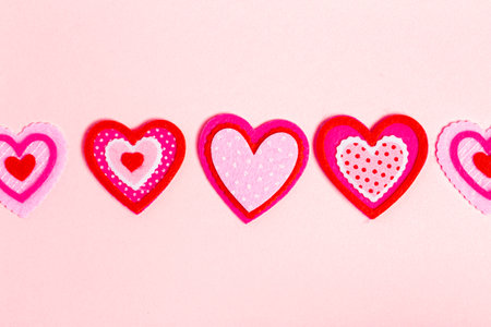 Simple Background with Felt Love Hearts on a Pink Backgroundの写真素材