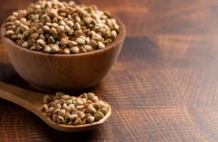 Buckwheat Grain on a Dark Wooden Butcher Blockの写真素材