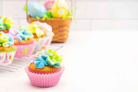 Pastel Rainbow Frosted Easter Cupcakes  on a White Kitchen Counter