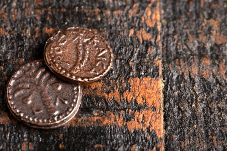 Two Small Copper Coins or Widows Mites on a Wooden Tableの写真素材