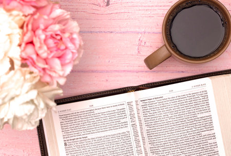 Personal Bible Study with a Cup of Hot Coffee on a Pink Tableの写真素材
