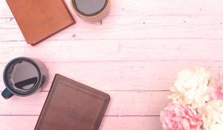 Group Bible Study with Hot Coffee on a Pink Wooden Tableの写真素材