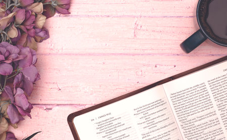 Personal Bible Study with a Cup of Hot Coffee on a Pink Tableの写真素材