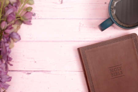 Personal Bible Study with a Cup of Hot Coffee on a Pink Tableの写真素材