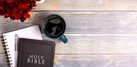 Single Bible and Cup of Coffee on a Distressed Wooden Tableの写真素材