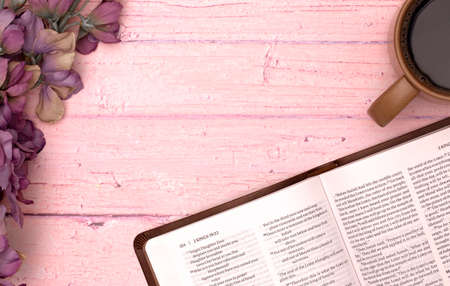 Personal Bible Study with a Cup of Hot Coffee on a Pink Tableの写真素材