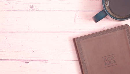 Personal Bible Study with a Cup of Hot Coffee on a Pink Tableの写真素材