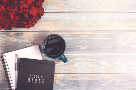 Single Bible and Cup of Coffee on a Distressed Wooden Tableの写真素材