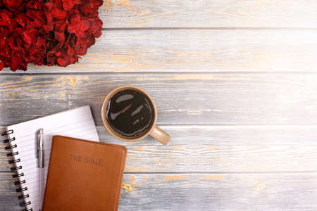 Single Bible and Cup of Coffee on a Distressed Wooden Tableの写真素材