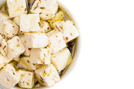 Bowl Filled with Cubed Feta Cheese Isolated on a White Backgroundの写真素材
