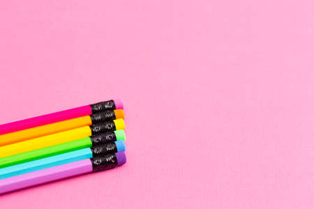 Background with Rainbow Pencils on a Bright Pink Table Great for Back to School