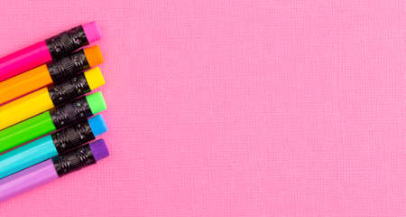 Background with Rainbow Pencils on a Bright Pink Table Great for Back to Schoolの写真素材