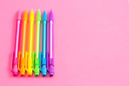 Background with Rainbow Mechanical Pencils on a Bright Pink Table Great for Back to Schoolの写真素材