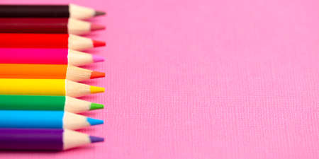 Set of Rainbow Colored Pencils on a Bright Pink Backgroundの写真素材