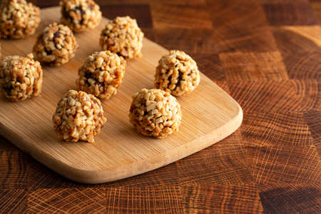 Chocolate Peanut Butter Energy Balls on Wooden Butcher Block