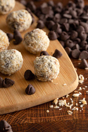 Coconut Chocolate Energy Balls on Wooden Butcher Blockの写真素材