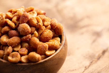 Honey Roasted Peanuts on a Dark Wooden Table