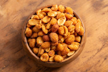Honey Roasted Peanuts on a Dark Wooden Tableの写真素材