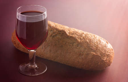 Bread and Wine for Holy Communion on a Red Surfaceの写真素材