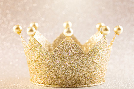 A Classic Golden Crown on a Golden Backgroundの写真素材