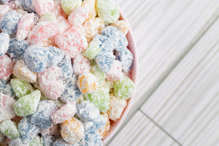 Rainbow Mini Mochi Rice Cake Candies on a White Wooden Tableの写真素材