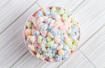 Rainbow Mini Mochi Rice Cake Candies on a White Wooden Tableの写真素材