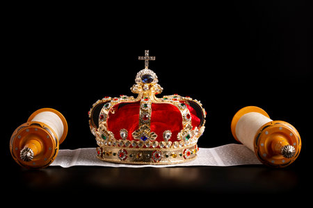 A Gold Coronation Crown with Red Velevet on a Bible on an Open Scrollの写真素材