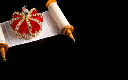 A Gold Coronation Crown with Red Velevet on a Bible on an Open Scrollの写真素材