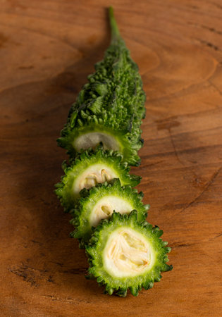 Green Bitter Gourd Melon on a Wooden Tableの写真素材