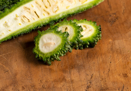 Green Bitter Gourd Melon on a Wooden Tableの写真素材