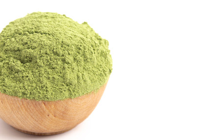 Bowl of Green Kale Powder Isolated on a White Backgroundの写真素材