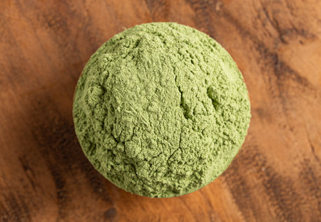Bowl of Green Kale Powder on a Wooden Counter Topの写真素材