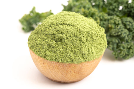 Bowl of Green Kale Powder Isolated on a White Backgroundの写真素材