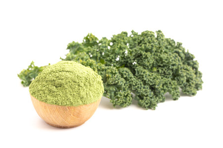 Bowl of Green Kale Powder Isolated on a White Backgroundの写真素材