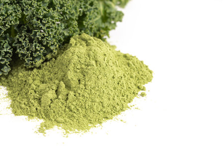 Pile of Green Kale Powder Isolated on a White Backgroundの写真素材