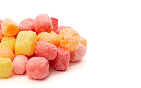 Freeze Dried Rainbow Flavored and Pastel Colored Chewy Candy Squares Isolated on a White Backgroundの写真素材