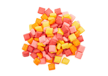 Pile of Rainbow Colored Small Chewy Square Candies Isolated on a White Backgroundの写真素材