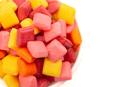 Pile of Rainbow Colored Small Chewy Square Candies Isolated on a White Backgroundの写真素材