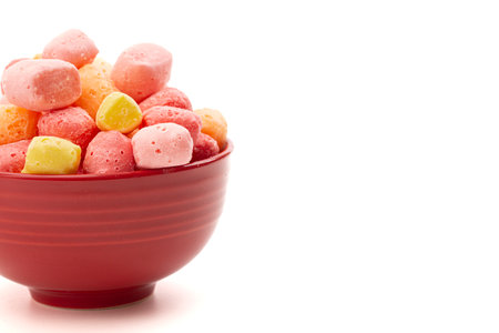 Freeze Dried Rainbow Flavored and Pastel Colored Chewy Candy Squares Isolated on a White Backgroundの写真素材