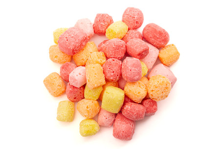 Freeze Dried Rainbow Flavored and Pastel Colored Chewy Candy Squares Isolated on a White Backgroundの写真素材