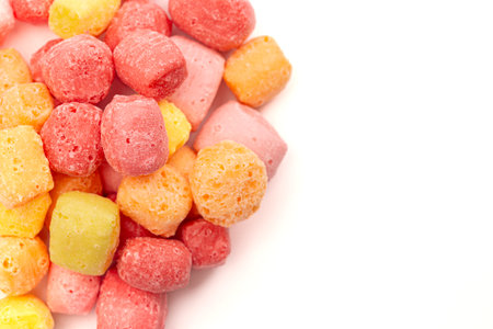 Freeze Dried Rainbow Flavored and Pastel Colored Chewy Candy Squares Isolated on a White Backgroundの写真素材
