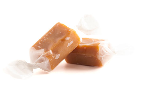 Hand Wrapped Soft Caramel Candies  Isolated on White Backgroundの写真素材