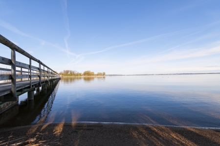 A look at a huge lake in the morning light の写真素材