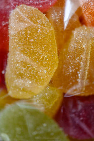 Sweet, colorful jelly fruits in transparent packaging invite you to enjoy them.の写真素材
