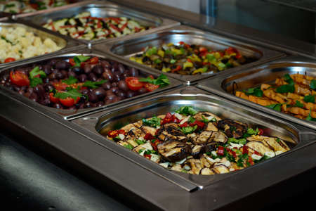 An antipasti buffet with grilled vegetables like eggplant, zucchini and carrots in an Italian...