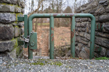 The entrance is locked with a very tiny door which is saved with a chain and a padlock.の写真素材