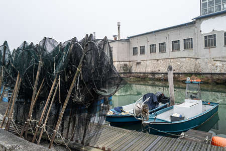 Two small fishing boats and prepared creels in an old fishing port.の写真素材