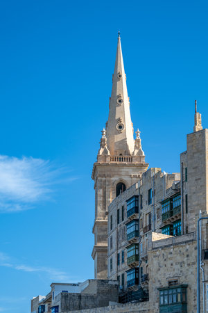 St. Paul's Anglican Pro-Cathedral's spire rises above Valletta, Malta. Built in the 19th century, it serves as a place of worship and a landmark.の写真素材