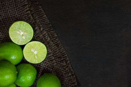 Limes on dark wood background